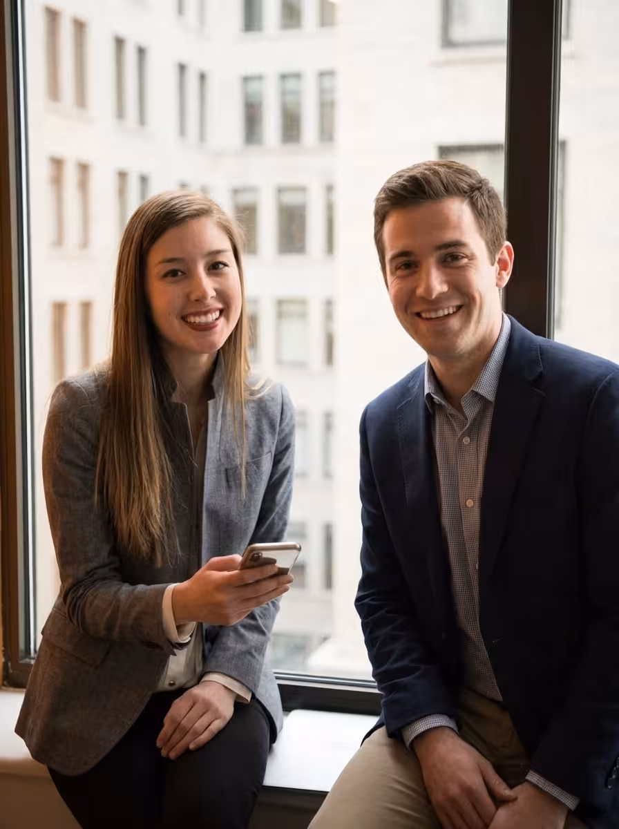 Two confident privacy professionals in a corporate office